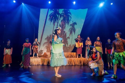 Moana — full-stage scene washed in saturated colour, lighting design
